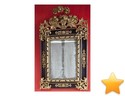 Miroir dans un bel encadrement en bois noirci � riches r�ha...