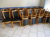 1-	Vingt deux chaises en hêtre assise skaï et deux banquettes murales